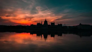 Silhouette of the Hungarian Parliament building reflected on the Danube at Sunset